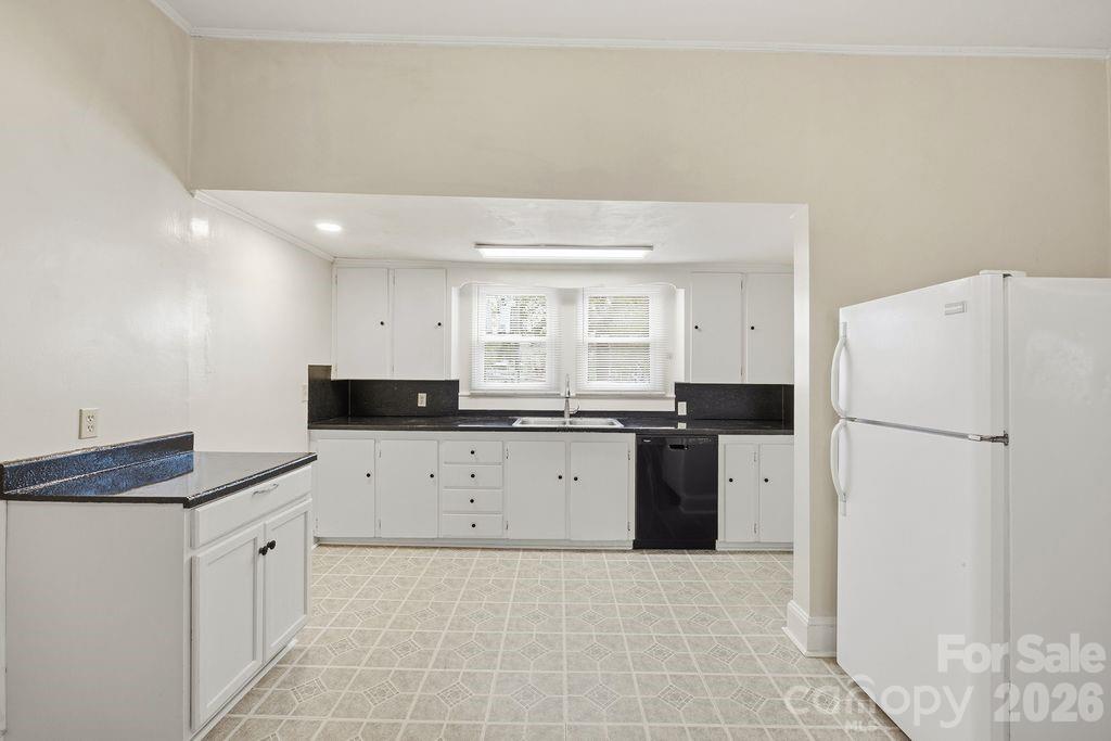 625 North Main Street Kannapolis, NC 28081 - Photo 3 of 26 a kitchen with a refrigerator a stove top oven and white cabinets