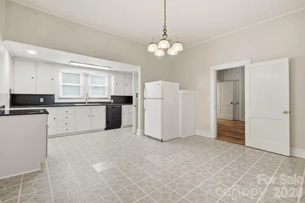 a kitchen with granite countertop a sink and a stove