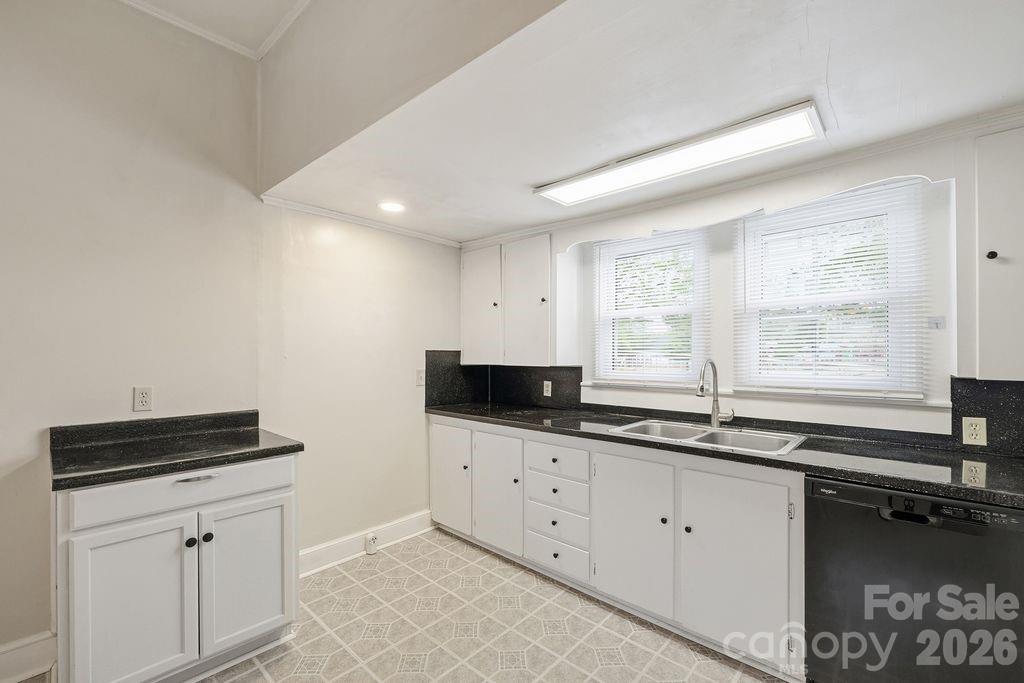 625 North Main Street Kannapolis, NC 28081 - Photo 6 of 26 a kitchen with granite countertop a sink and a stove
