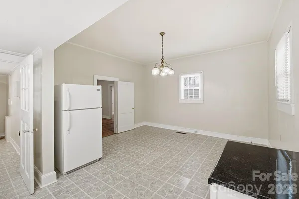 a view of a livingroom with a kitchen sink stove and microwave