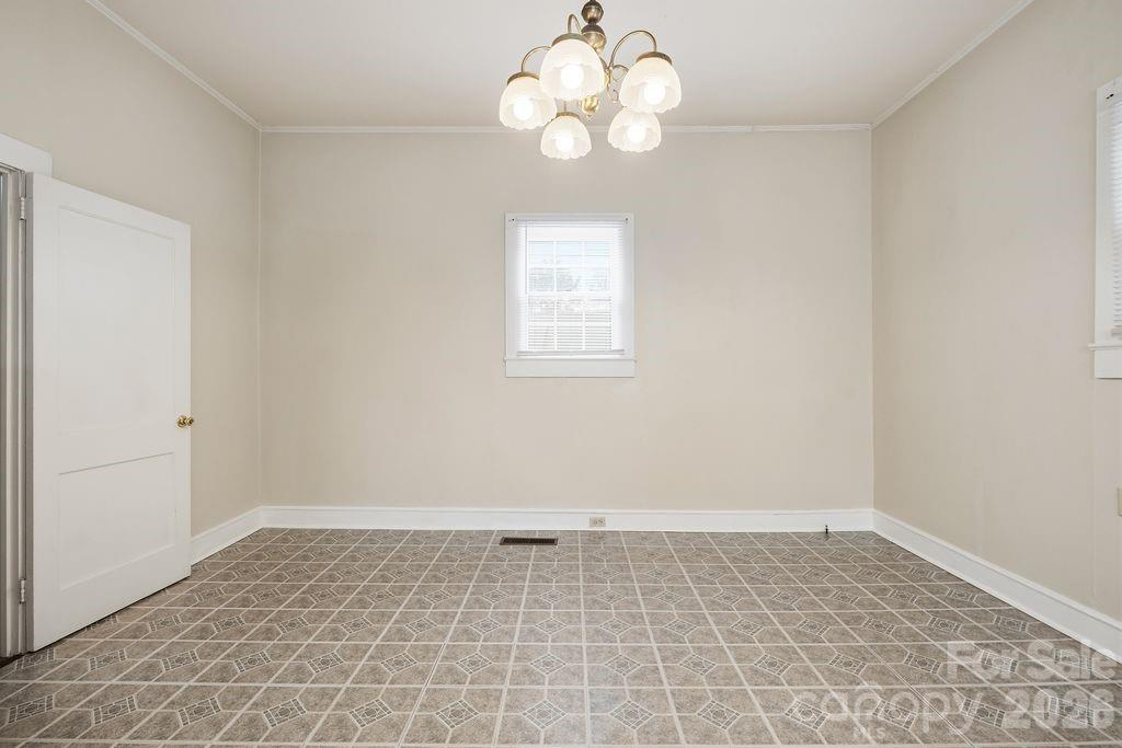 625 North Main Street Kannapolis, NC 28081 - Photo 9 of 26 an empty room with a chandelier fan and windows