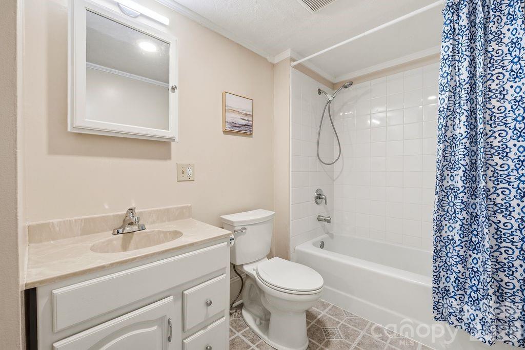 625 North Main Street Kannapolis, NC 28081 - Photo 10 of 26 a bathroom with a sink a toilet and shower