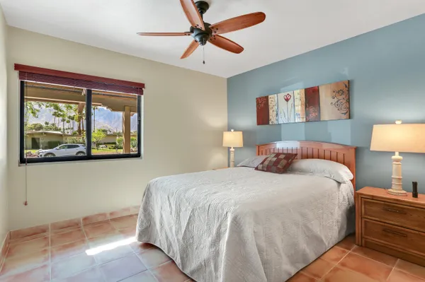 a bedroom with a bed and a painting on the wall