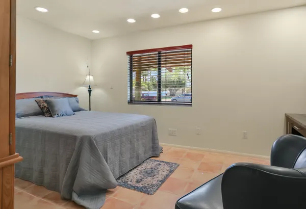 a bedroom with a bed and a couch