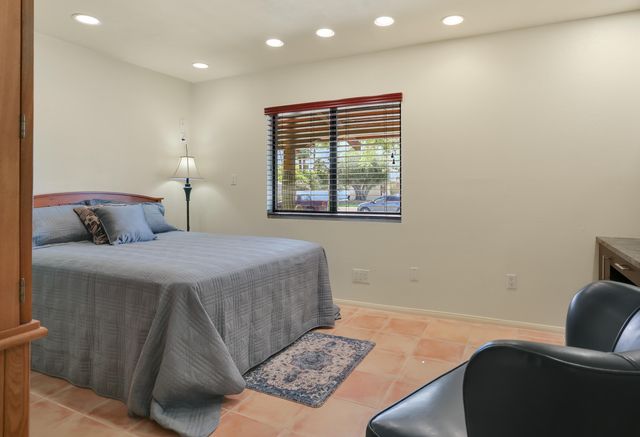 a bedroom with a bed and a couch