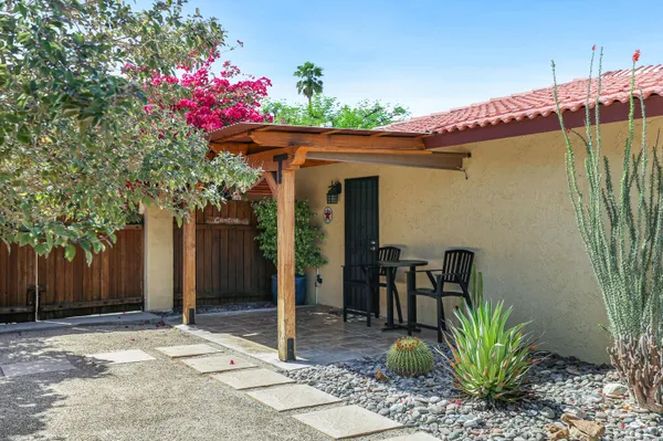 an outdoor sitting area with furniture and garden