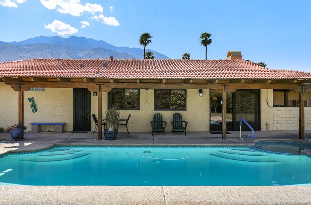 a view of a house with backyard porch and sitting area