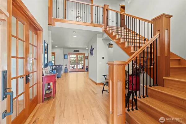 a kitchen with stainless steel appliances kitchen island granite countertop a table chairs and a refrigerator