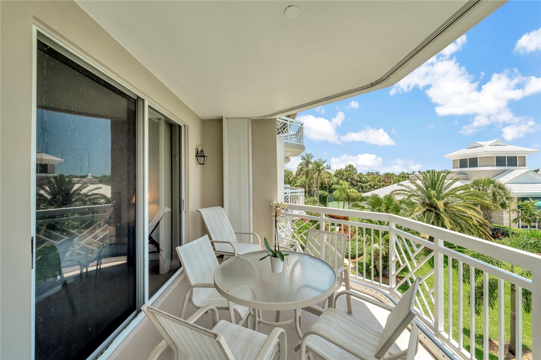 940 Turtle Cove Lane, Unit 208 Vero Beach, FL 32963 - Photo 11 of 35 a balcony with table and chairs