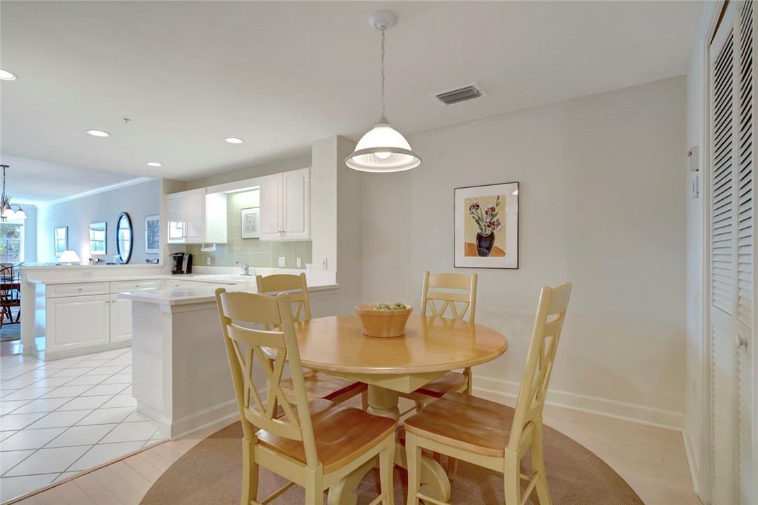 940 Turtle Cove Lane, Unit 208 Vero Beach, FL 32963 - Photo 13 of 35 a view of a dining room with furniture and wooden floor
