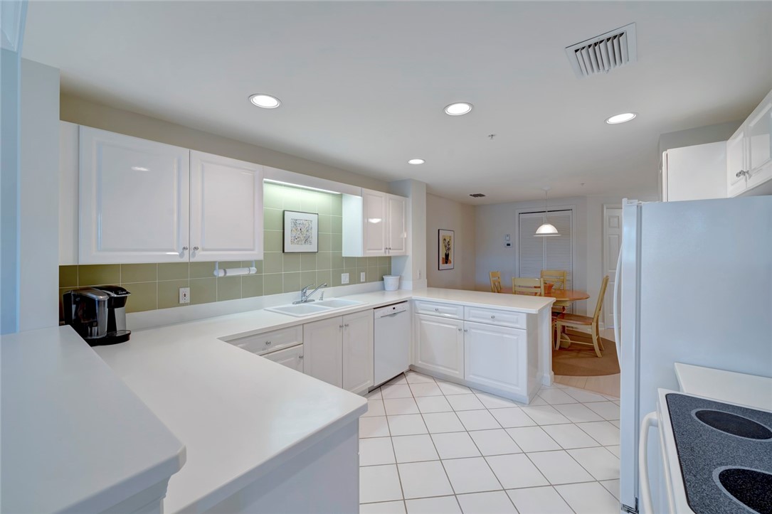 940 Turtle Cove Lane, Unit 208 Vero Beach, FL 32963 - Photo 15 of 35 a kitchen with a sink cabinets and counter space