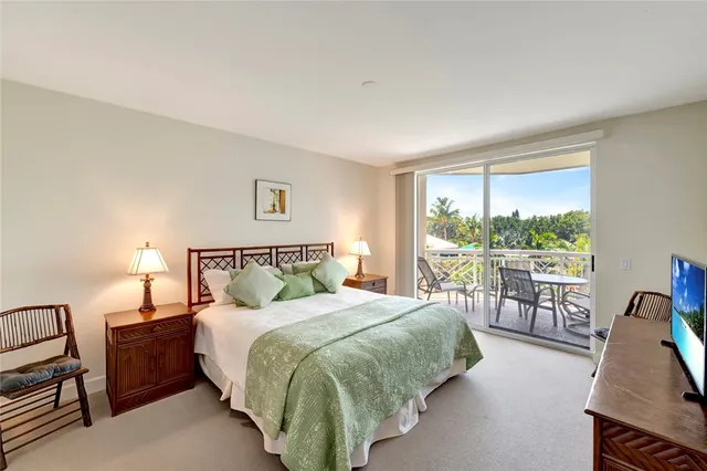 a bed sitting in a bedroom next to a large window