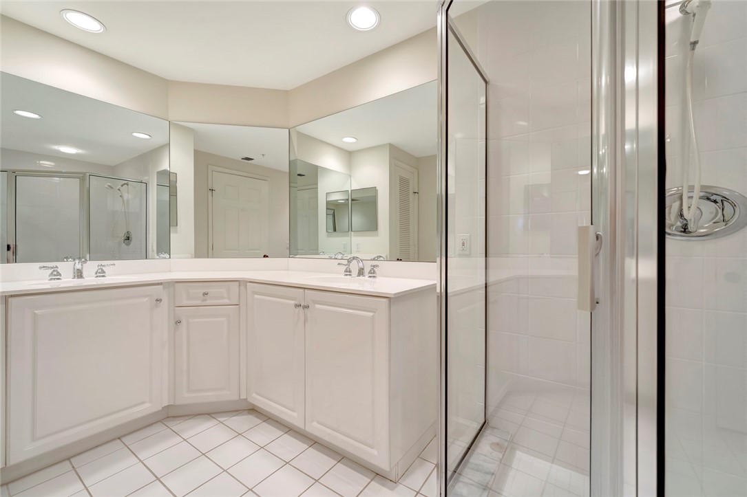 940 Turtle Cove Lane, Unit 208 Vero Beach, FL 32963 - Photo 21 of 35 a spacious bathroom with a shower a sink and a mirror