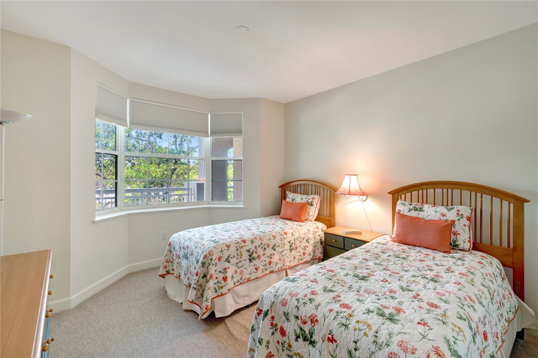 940 Turtle Cove Lane, Unit 208 Vero Beach, FL 32963 - Photo 23 of 35 a bedroom with two beds and window