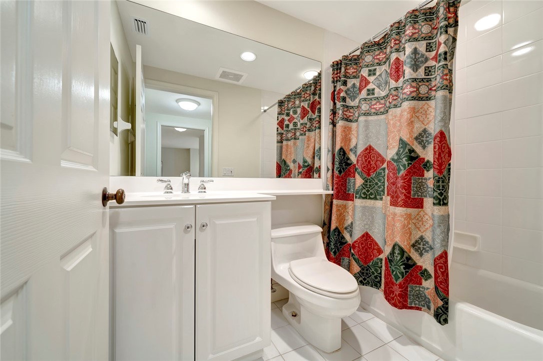940 Turtle Cove Lane, Unit 208 Vero Beach, FL 32963 - Photo 25 of 35 a bathroom with a sink mirror vanity and toilet