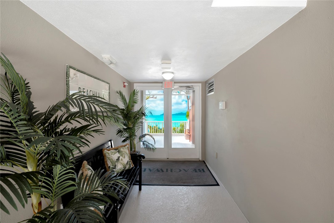 940 Turtle Cove Lane, Unit 208 Vero Beach, FL 32963 - Photo 28 of 35 a view of entryway with a floor to ceiling window and potted plants