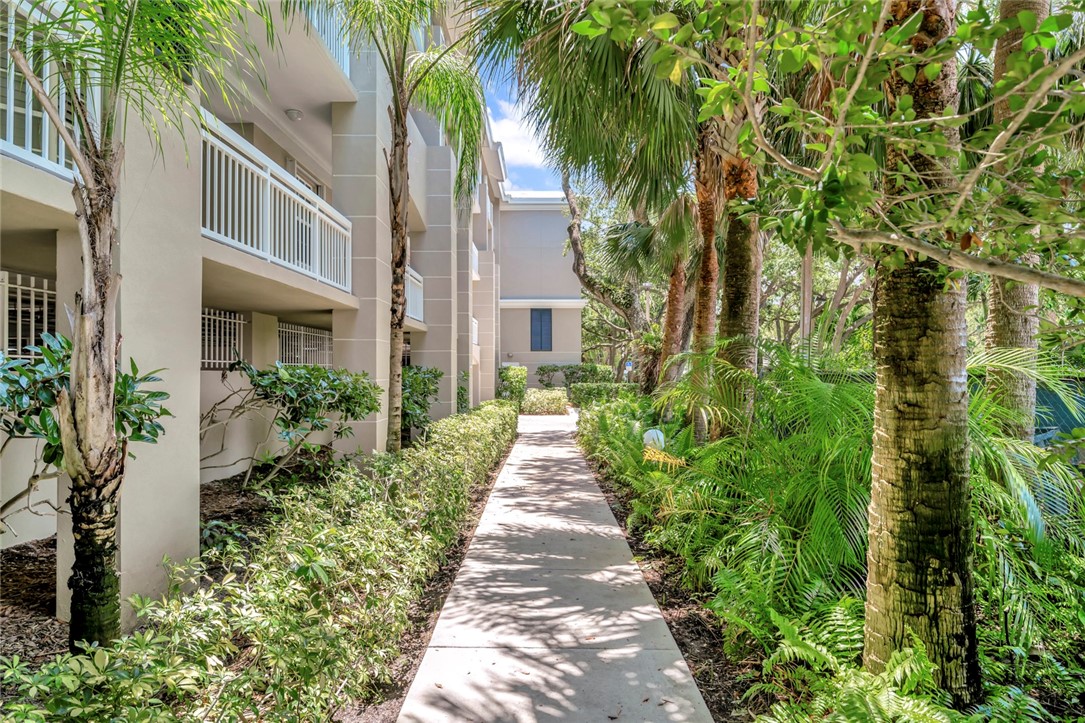 940 Turtle Cove Lane, Unit 208 Vero Beach, FL 32963 - Photo 33 of 35 a view of a pathway with house on both side