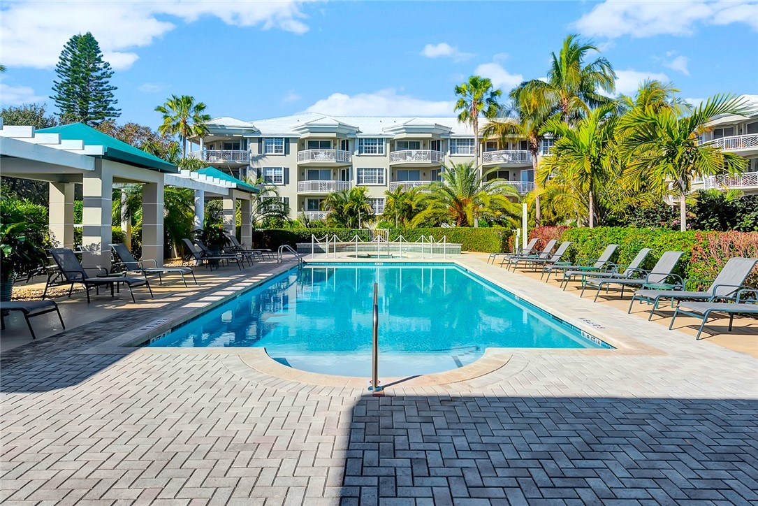940 Turtle Cove Lane, Unit 208 Vero Beach, FL 32963 - Photo 35 of 35 a view of a swimming pool with a lounge chairs