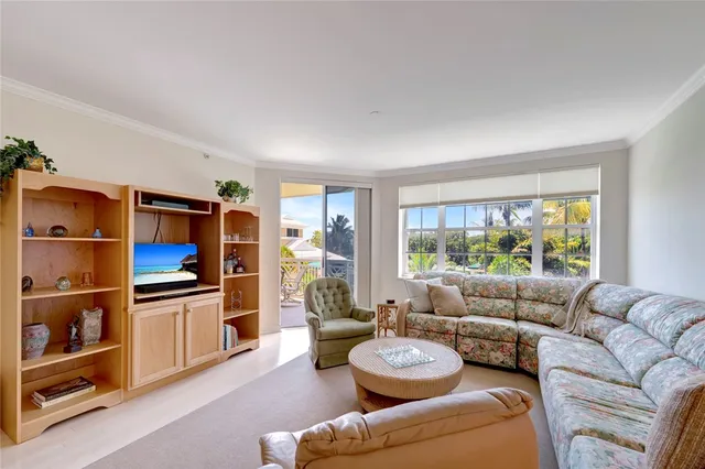 a living room with furniture a rug and a large window