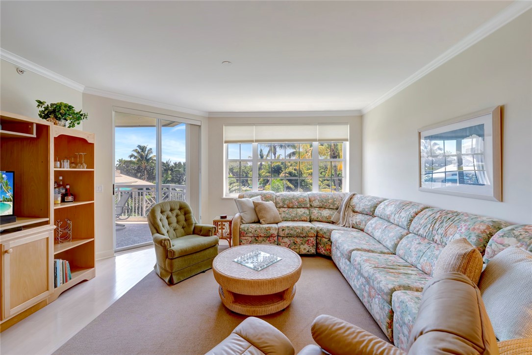 940 Turtle Cove Lane, Unit 208 Vero Beach, FL 32963 - Photo 8 of 35 a living room with furniture and a large window