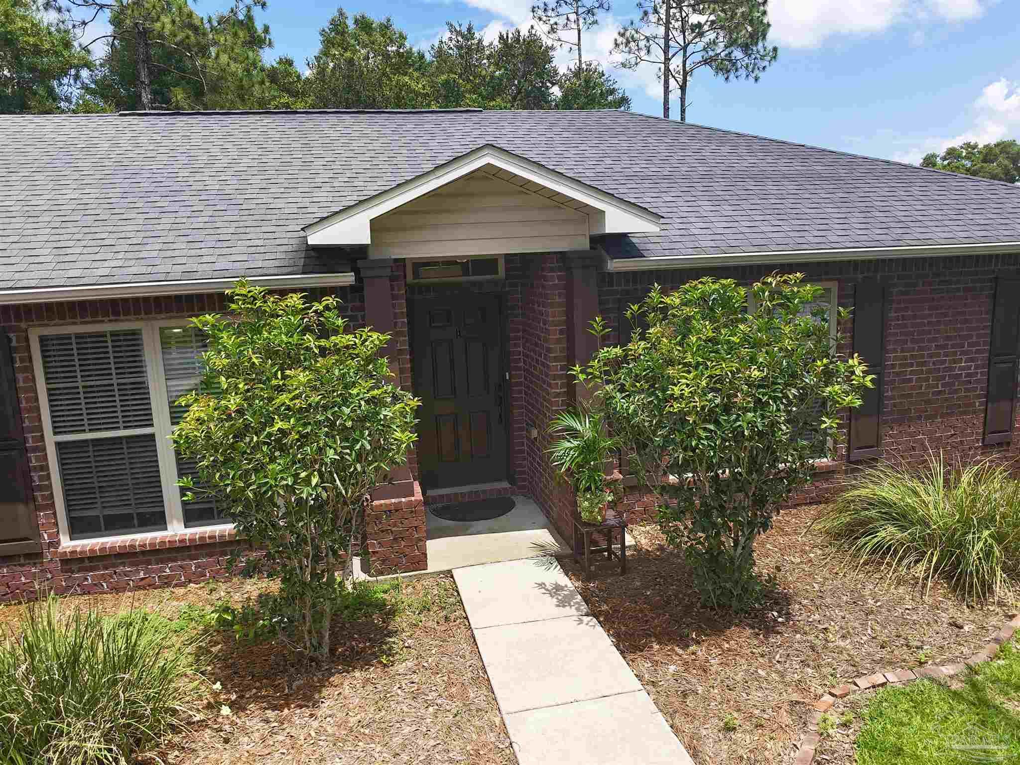 5709 Mill Stream Way Pace, FL 32571 - Photo 14 of 48 a front view of a house with garden