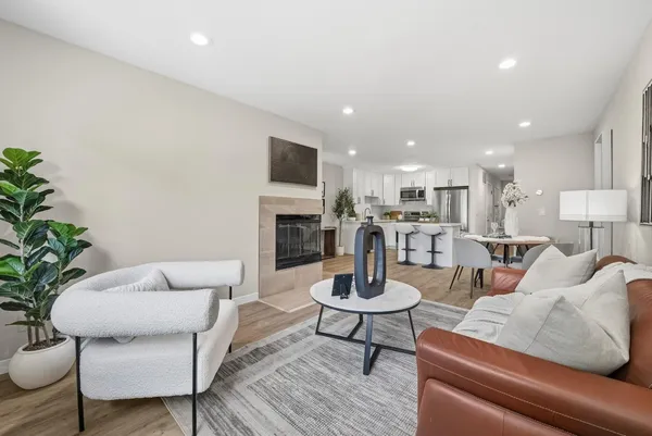 a living room with furniture and a fireplace