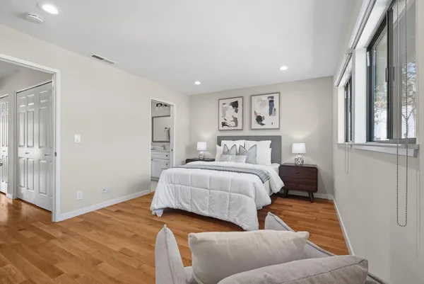 a bedroom with a large bed and a couch