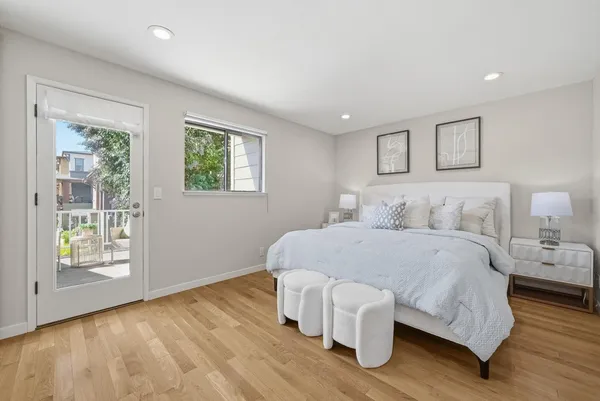 a bedroom with a bed and a large window