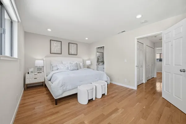 a spacious bedroom with a bed and a table