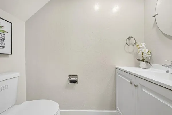 a bathroom with a sink a toilet and vanity