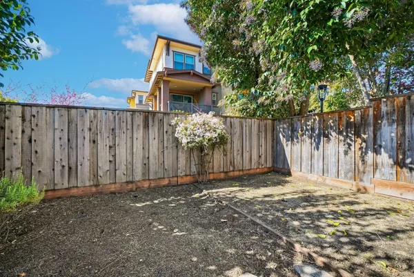 a backyard of a house with table and chairs
