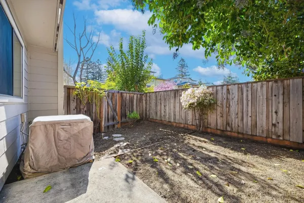 a backyard of a house with table and chairs