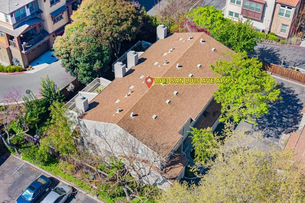 a view of a multi story building with a yard