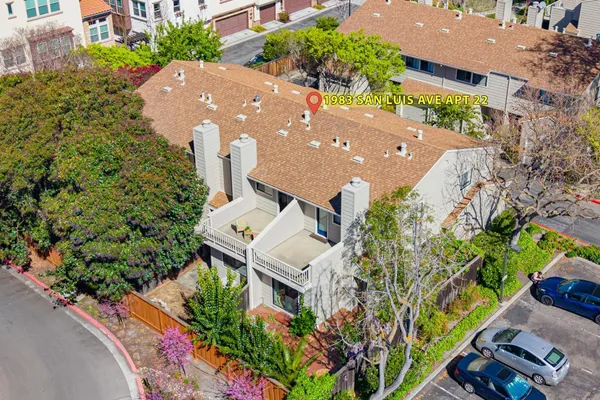 a view of a balcony with flower plants