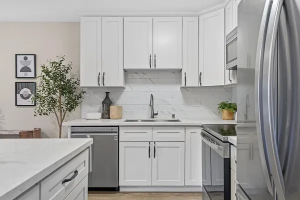 a kitchen with white cabinets and a stainless steel appliances