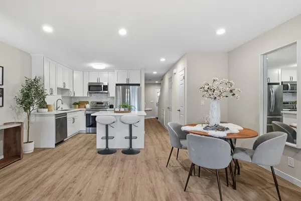 a kitchen with a table and chairs in it