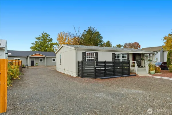 a view of a house with a yard and sitting area