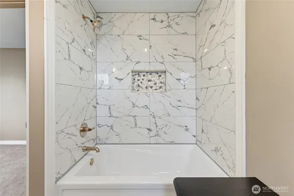 a bathroom with a bathtub and shower