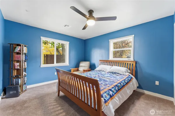 a bedroom with a large bed and a chandelier