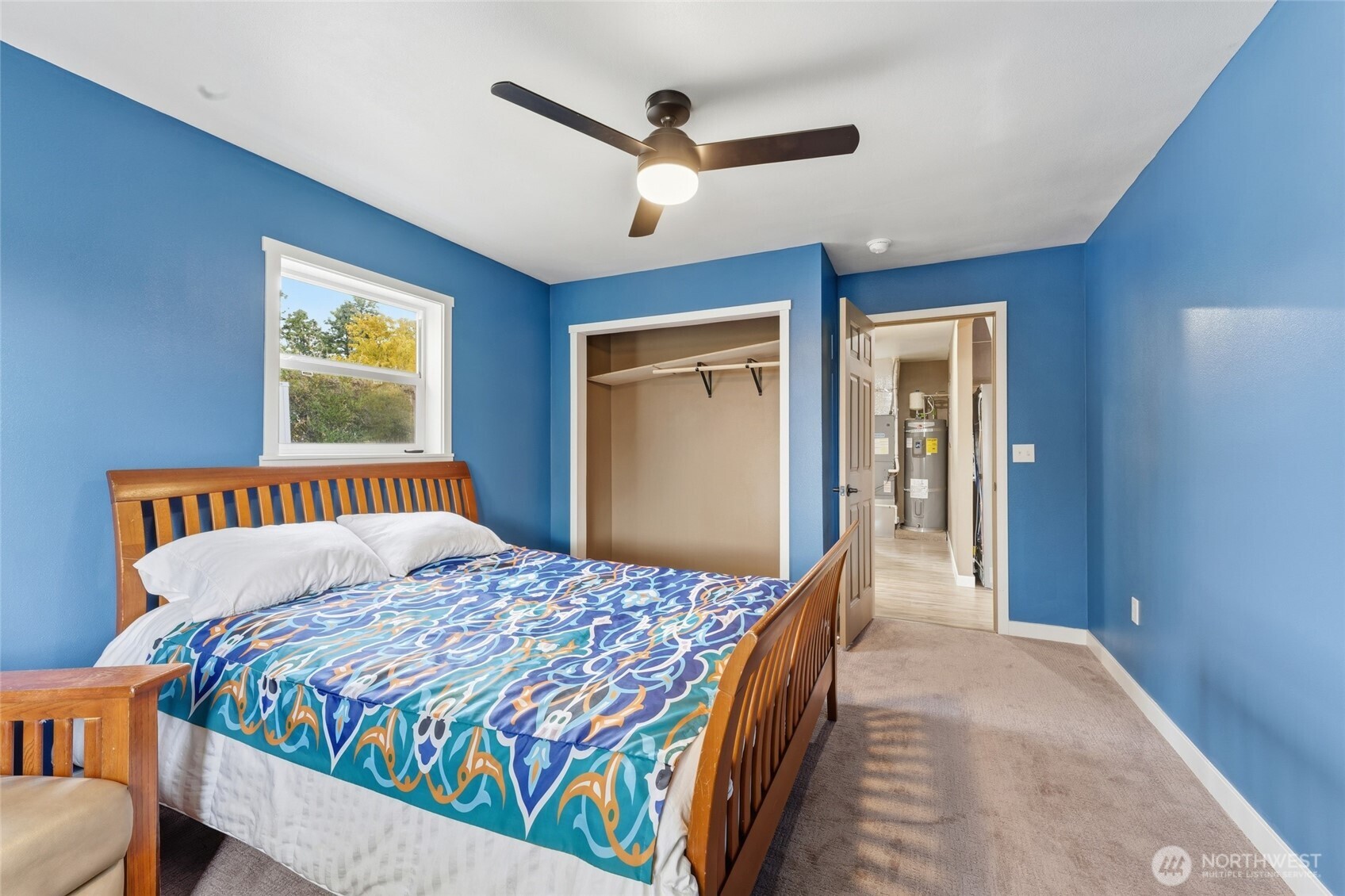 905 Cowl Street Milton Freewater, OR 97862 - Photo 16 of 32 a bedroom with a large bed and a chandelier