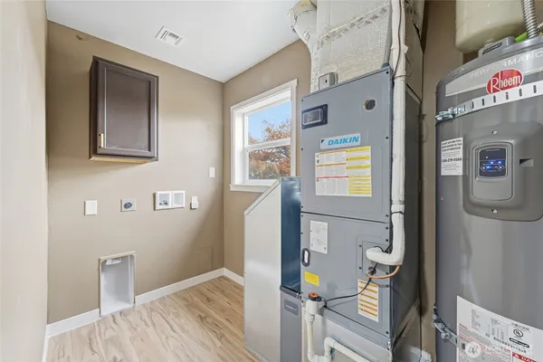 a living room with furniture a flat screen tv and a large window