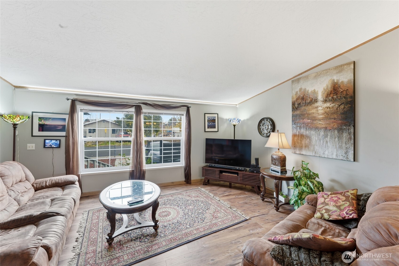 905 Cowl Street Milton Freewater, OR 97862 - Photo 19 of 32 a living room with furniture a flat screen tv and a large window