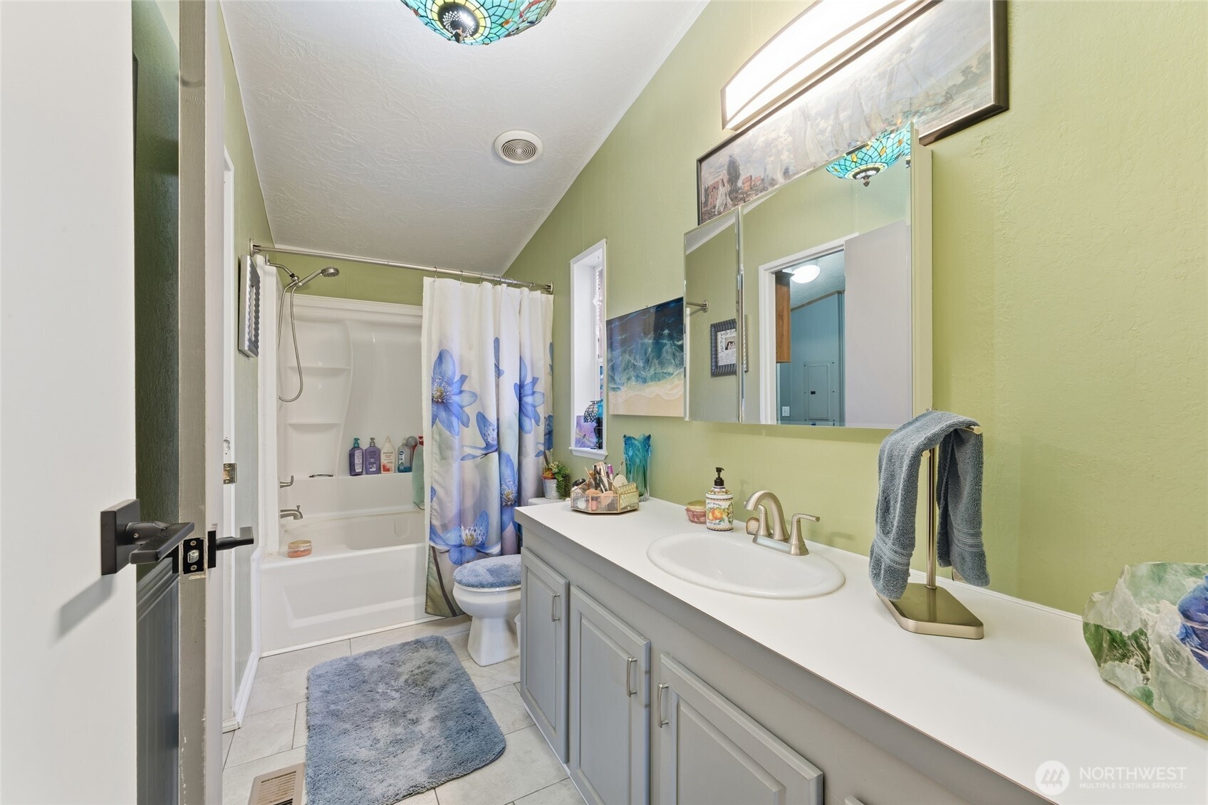 905 Cowl Street Milton Freewater, OR 97862 - Photo 24 of 32 a bathroom with a sink a toilet a mirror and shower