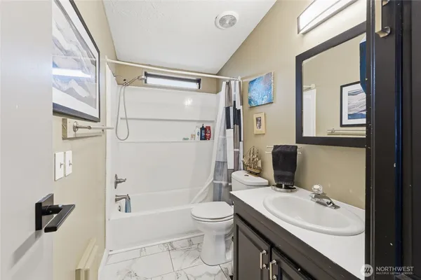 a bed room with a bed and a chair