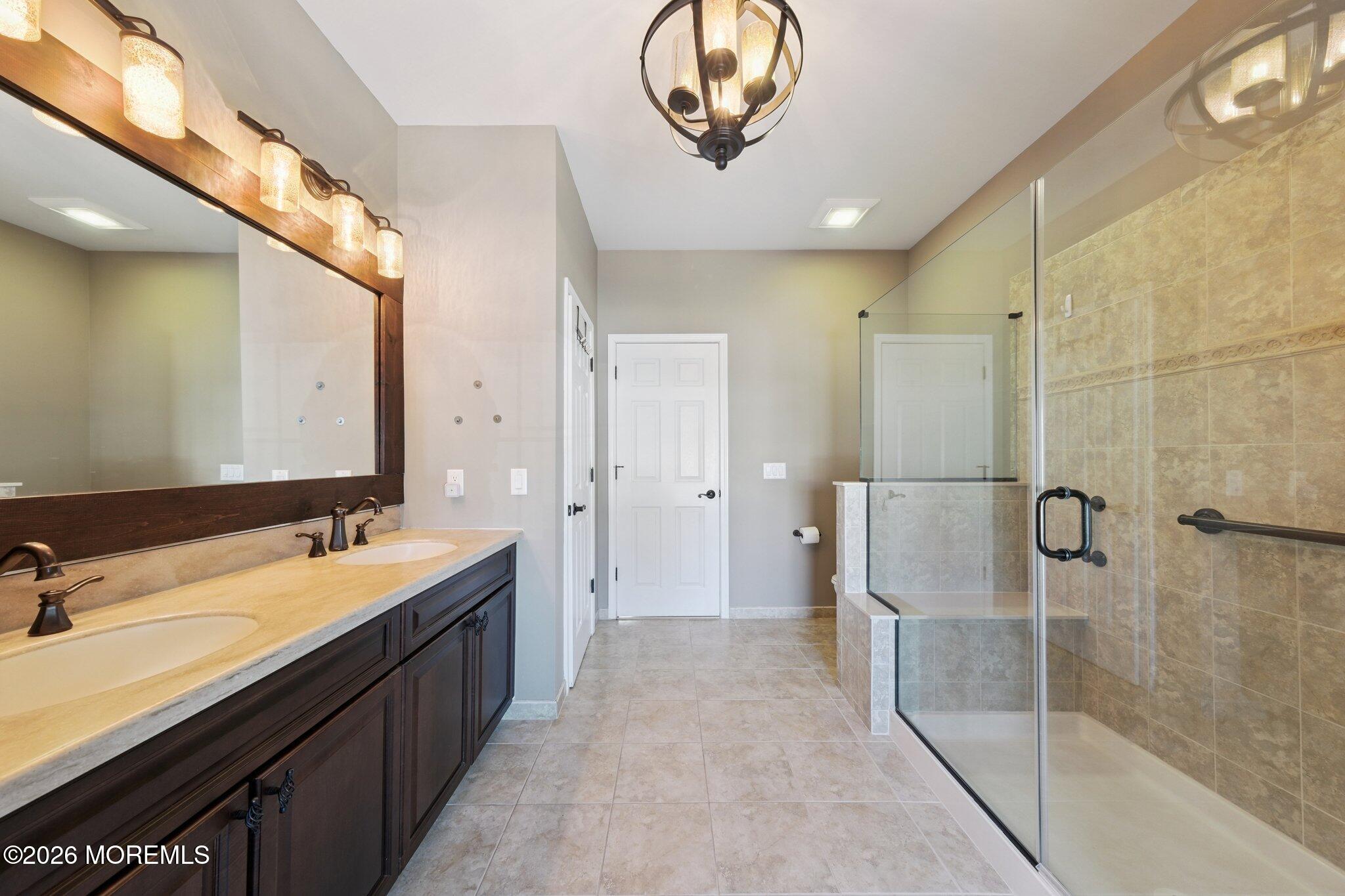 8 Patton Court Manalapan, NJ 07726 - Photo 11 of 23 a bathroom with a double vanity sink mirror and shower