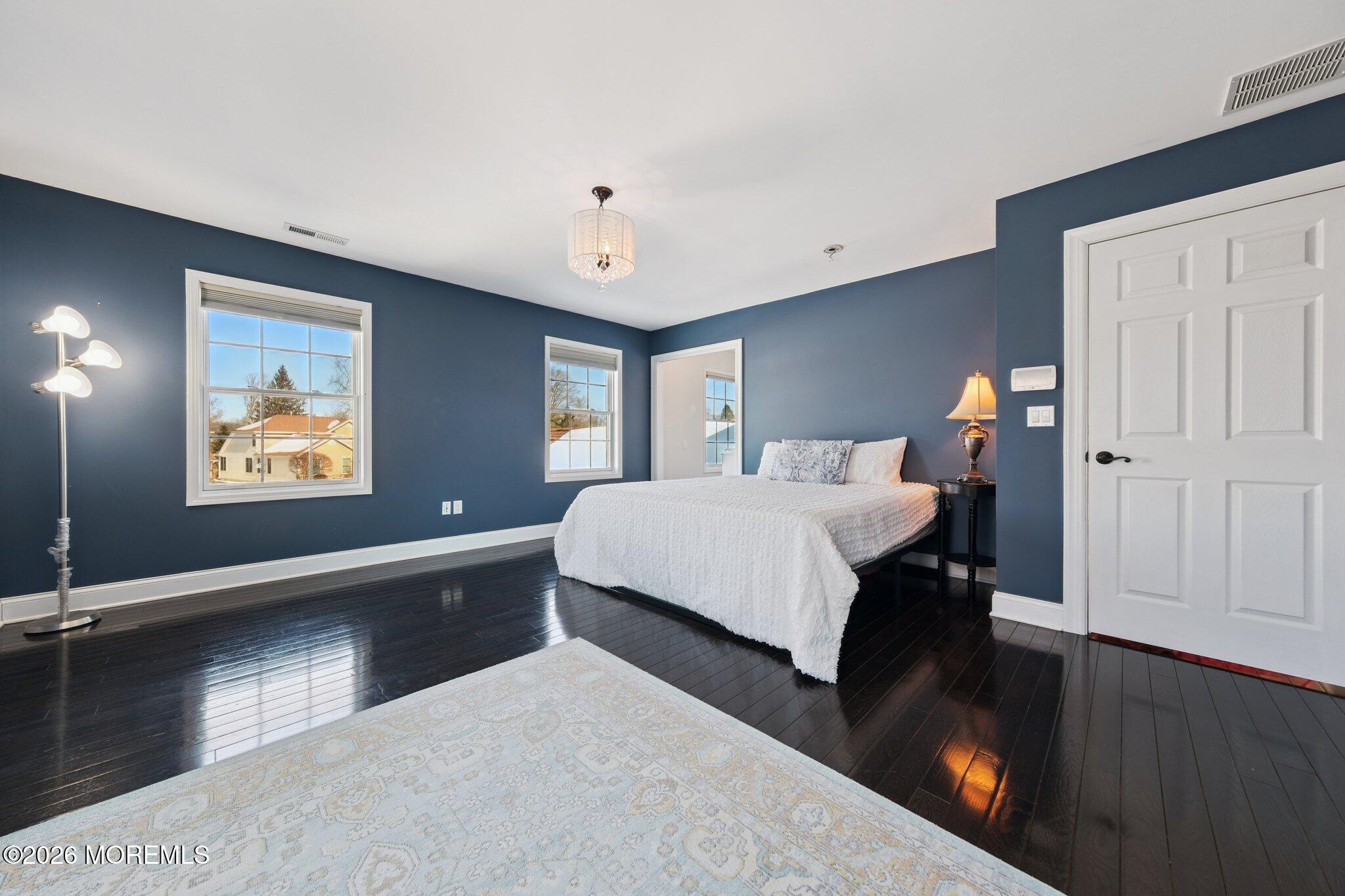 8 Patton Court Manalapan, NJ 07726 - Photo 13 of 23 a spacious bedroom with a bed and a view of kitchen