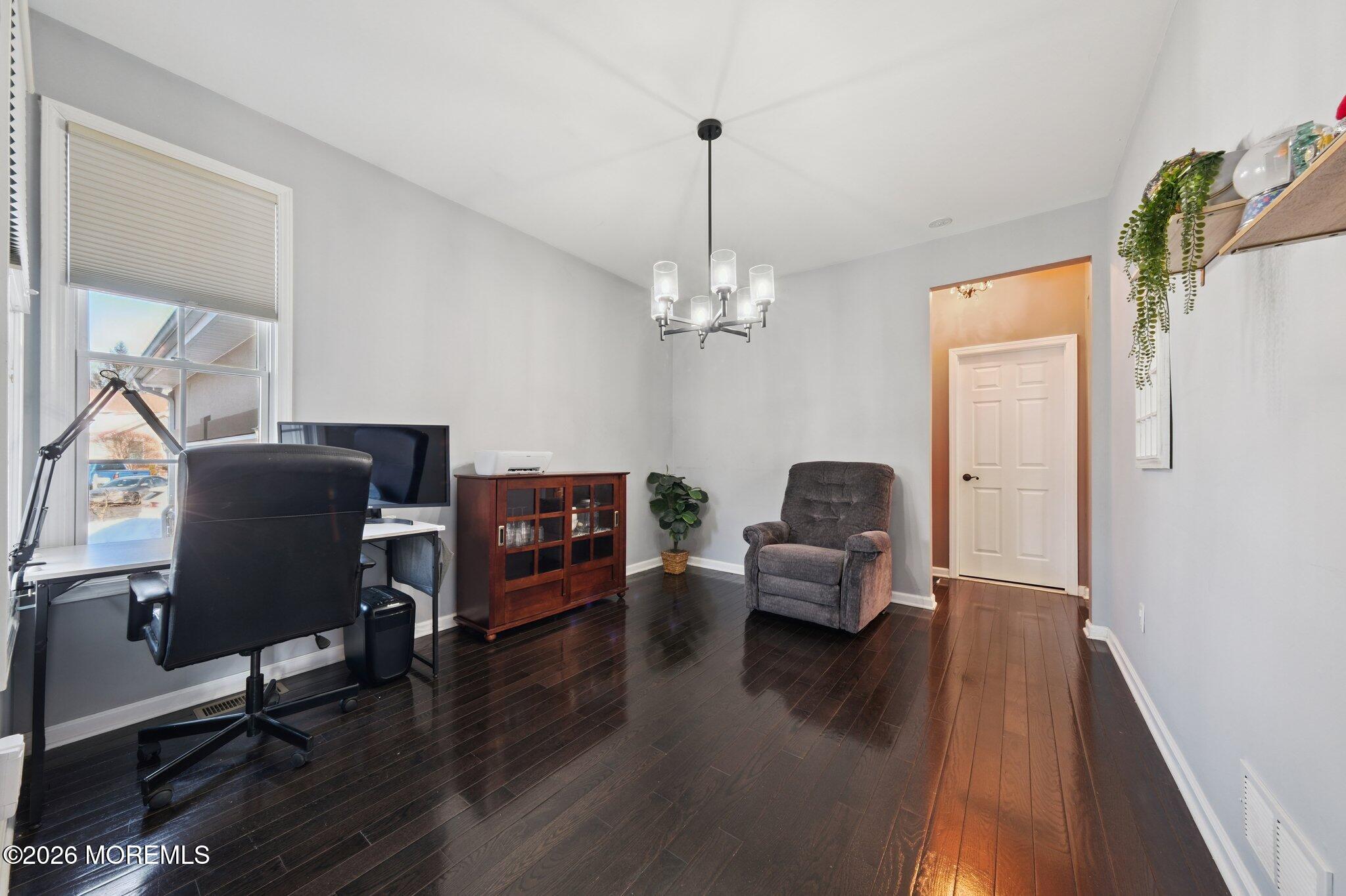 8 Patton Court Manalapan, NJ 07726 - Photo 17 of 23 a living room with furniture and a chandelier
