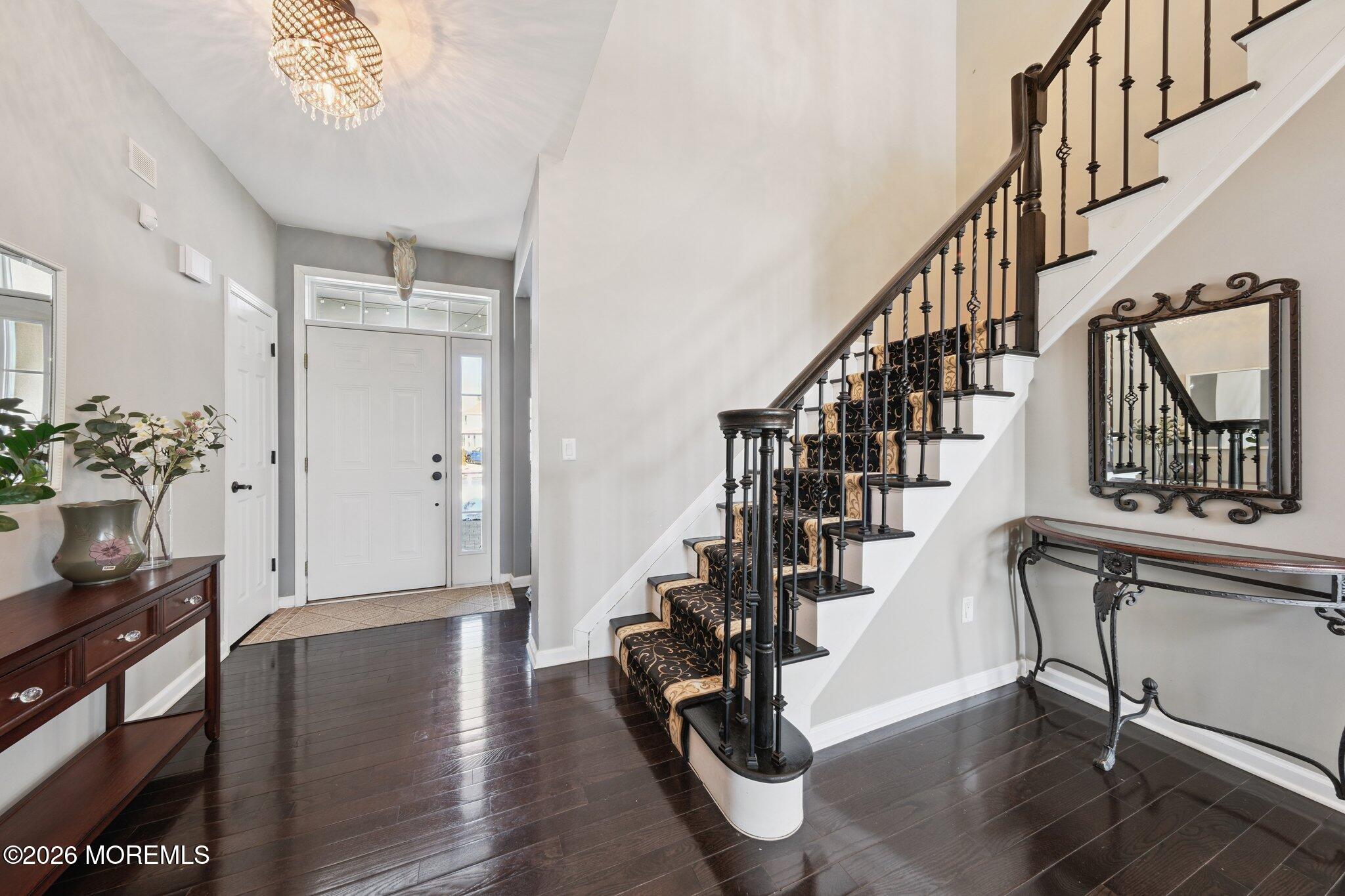 8 Patton Court Manalapan, NJ 07726 - Photo 3 of 23 a view of entryway and hall with wooden floor