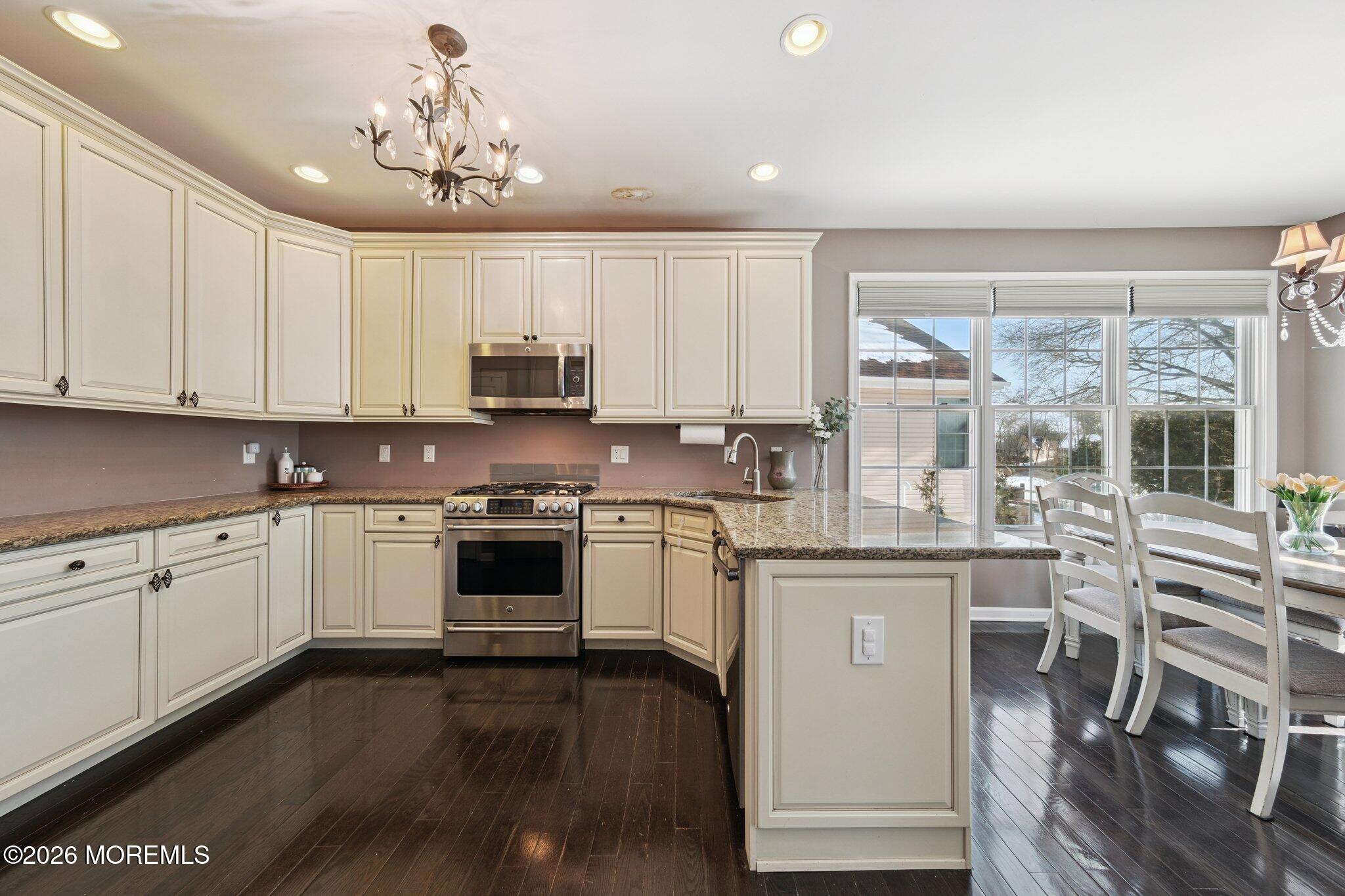 8 Patton Court Manalapan, NJ 07726 - Photo 4 of 23 a kitchen with stainless steel appliances granite countertop a stove and cabinets