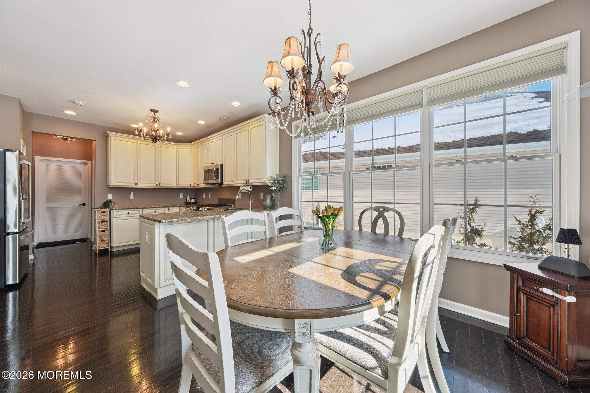 8 Patton Court Manalapan, NJ 07726 - Photo 5 of 23 a kitchen with kitchen island a large counter top space appliances and a dining table